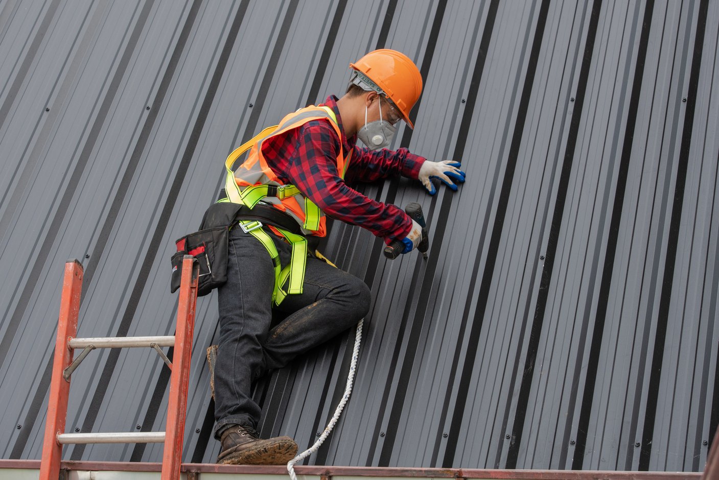 Roofer Installing Metal Sheet